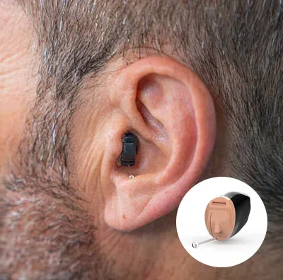 Close-up of a man's ear wearing an invisible-in-canal (IIC) hearing aid; only the small pulling stick is barely visible.